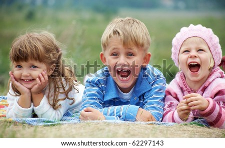 stock-photo-portrait-of-group-laughing-children-lying-on-the-grass-62297143.jpg