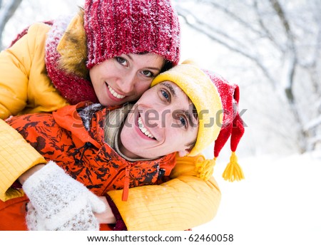 The young family plays winter wood on snow in Valentine's day