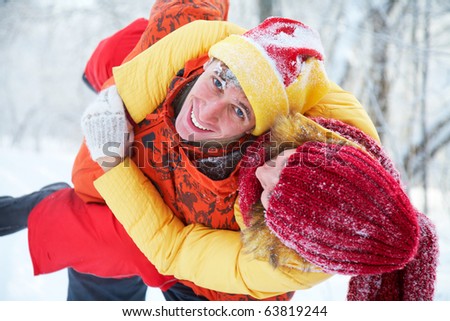 young family plays winter wood on snow in Valentine\'s day