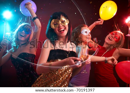 Dance happy young girls under masks on the party