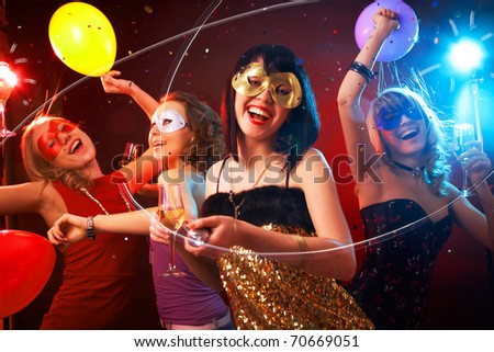 Dance happy young girls under masks on the party