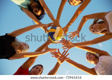 group of young people playing volleyball on the beach group of young people playing volleyball on the beach