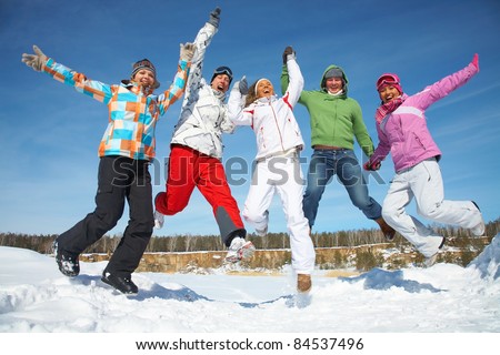Group of  teenagers jumping together in wintertime