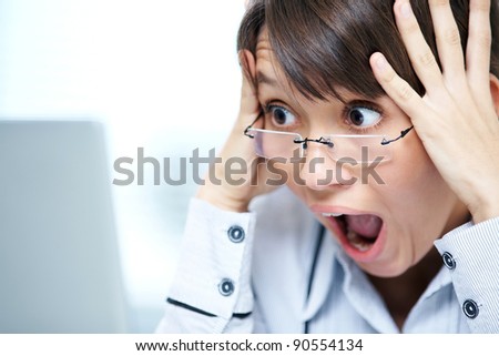 young girl in a horror crying in front of the monitor laptop