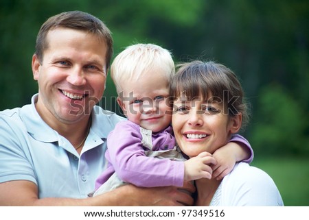 Happy couple with their little son having good time together
