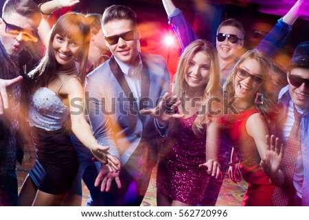 Group of young people having fun dancing at  party.