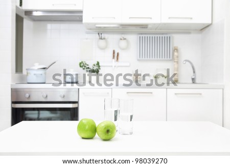 Interior Of Small White Kitchen With Fresh Apples On The Table