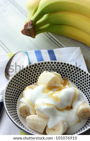 Healthy snack of banana, yogurt and honey