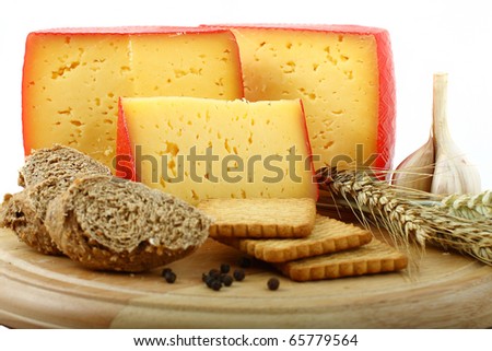 board with pieces of cheese, grain bread and biscuits