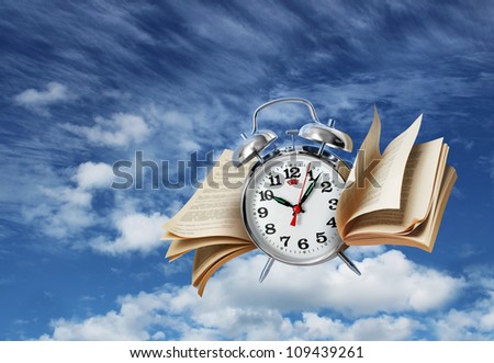 Old alarm clock flying with page wings, time flies concept