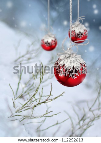Red Christmas balls in beautiful winter snowfall fantasy