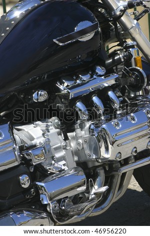 Polished chromed motorcycle engine shining in bright noon light