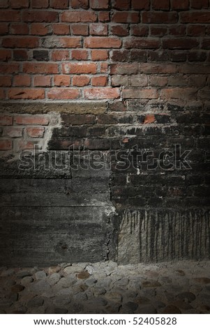 Dark brick and concrete wall with dramatic spot lighting