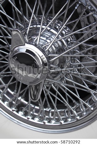 stock photo Shiny chromed spoke wheel of a classic sports car