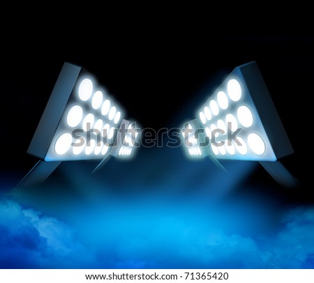 Stadium style lights illuminating blue surface premiere with color smoke