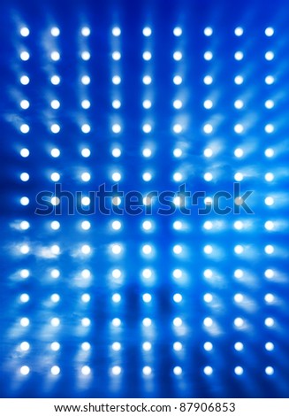 Rock stage spotlights background blurred by blue smoke effect