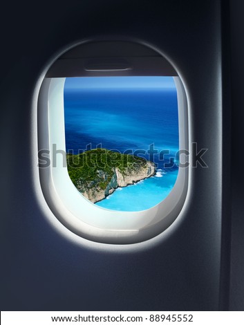 Approaching island holiday destination, jet plane window sky view