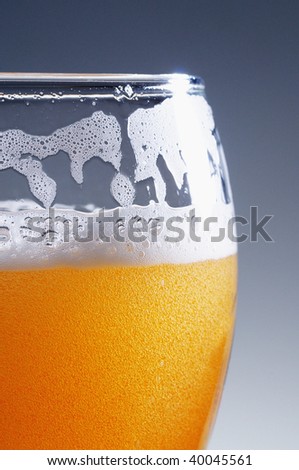 Glass of cold light beer close up