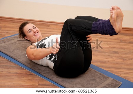 Young plump woman coaches her stomach muscles