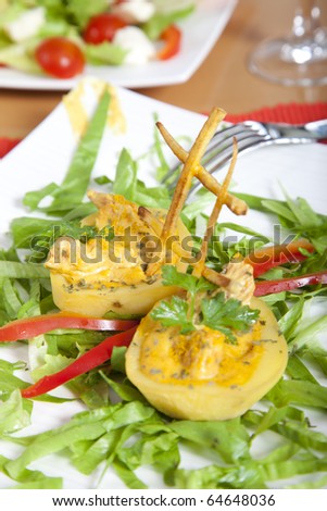 Two potatoes filled with curry sauce and meat on a plate