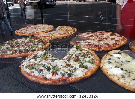 Pizza pies as seen through restaurant window, New York City