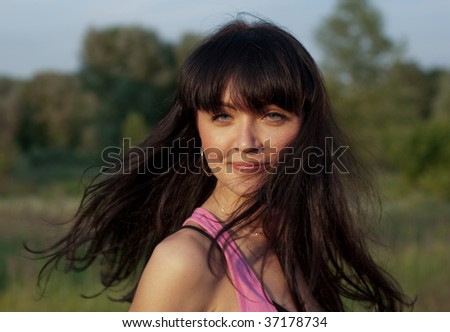 a girl turns around and hairs develop on wind