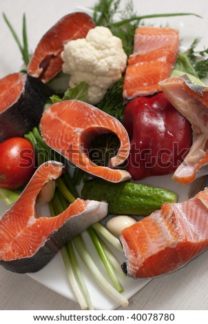 few stakes of a trout with vegetables on a plate
