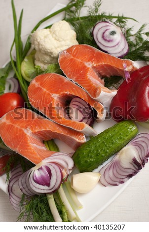 Stake of a salmon with vegetables on a plate