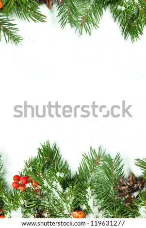 Christmas background with snow, cones and holly berry isolated on white