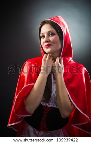 Beautiful woman in carnival costume. Little Red Riding Hood shape. Isolated on black