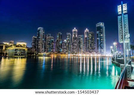 DUBAI, UAE - NOVEMBER 13: Dubai downtown night scene with city lights, luxury new high tech town in middle East, United Arab Emirates architecture