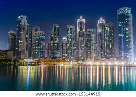 DUBAI, UAE - NOVEMBER 13: Dubai downtown night scene with city lights, luxury new high tech town in middle East, United Arab Emirates architecture on November 13, 2012 in Dubai, UAE