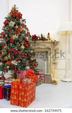 Decorated Christmas Tree And Gift Boxes In Living Room