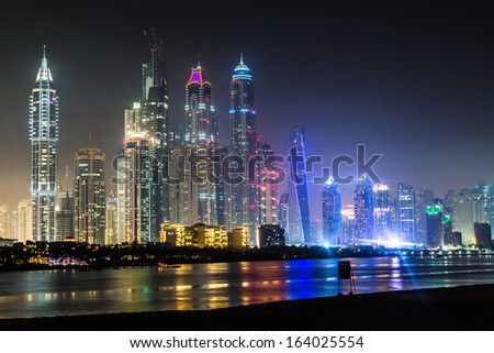 DUBAI, UAE - NOVEMBER 13: Dubai downtown night scene with city lights, luxury new high tech town in middle East, United Arab Emirates architecture. Dubai Marina cityscape, UAE