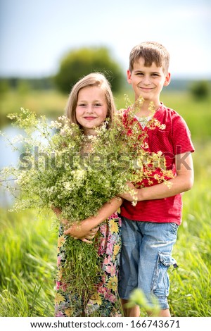 couple in love, boy gives a girl a bouquet of wild flowers