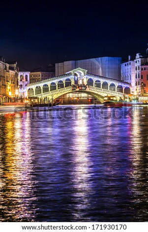 VENICE, ITALY - JULY 02: Tourist enjoy day and night on the Rialto Bridge on July 02, 2013 in Venice, Italy. Originally built out of wood and having collapsed, in 1591 was completed out of stone.