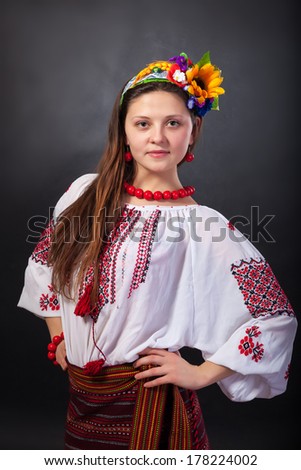 Attractive woman wears Ukrainian national dress isolated on a black background
