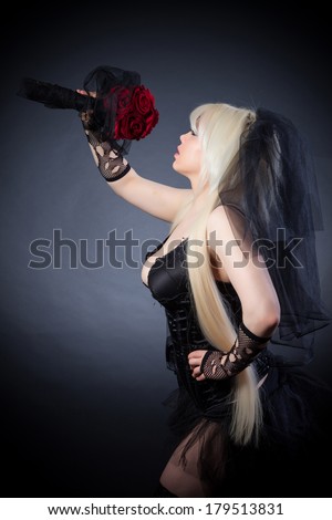 black widow in grief  with flowers  with a veil on a black background