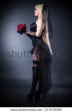 black widow in grief  with flowers  with a veil on a black background