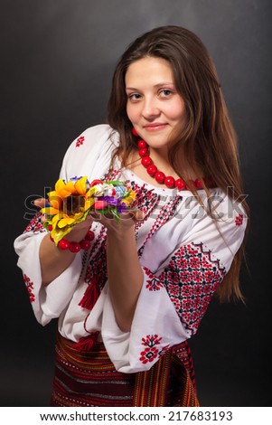 Attractive woman wears Ukrainian national dress isolated on a black background