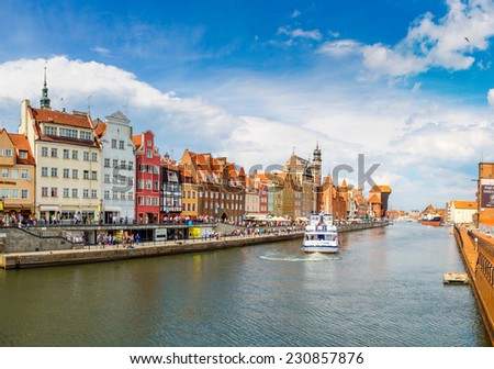 GDANSK, POLAND - JUNE 9: Tourist ship and colourful historic houses reflection Motlawa river in port of Gdansk on 9th June 2014, Baltic Sea, Poland.