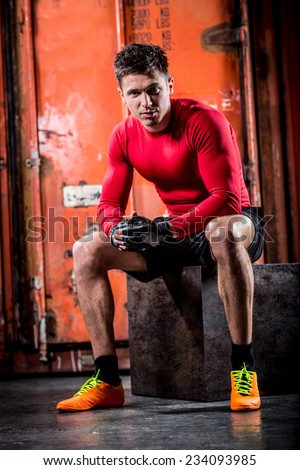 Sexy fashion portrait of a hot male model with muscular body posing in studio.Glamour colors