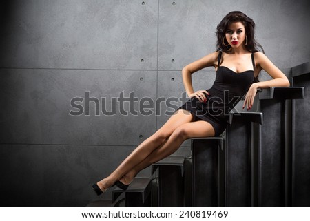 sexy woman lying on stairs at backyard of building