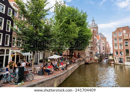 AMSTERDAM, NETHERLANDS - AUGUST 19: Canal and St. Nicolas Church in Amsterdam. Amsterdam is the capital and most populous city of the Netherlands on August 19, 2014