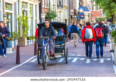 AMSTERDAM, NETHERLANDS - AUGUST 19:  People riding bicycles in historical part in Amsterdam, Netherlands on August 19, 2014