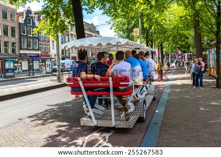 AMSTERDAM, NETHERLANDS - AUGUST 19:  People riding beer bicycle in historical part in Amsterdam, Netherlands on August 19, 2014