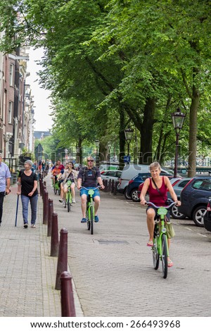 AMSTERDAM, NETHERLANDS - AUGUST 19:  People riding bicycles in historical part in Amsterdam, Netherlands on August 19, 2014