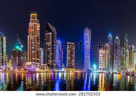 DUBAI, UAE - NOVEMBER 13: Dubai downtown night scene with city lights, luxury new high tech town in middle East. Dubai Marina cityscape,  on November 13, 2012 in Dubai, UAE.