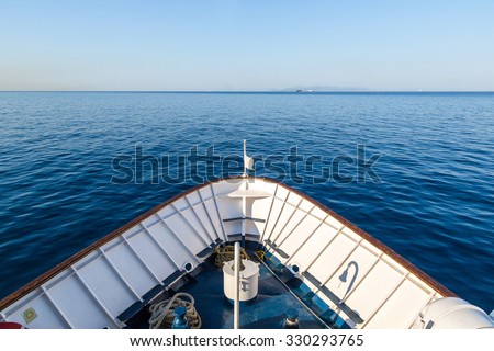 Ship in open sea is showing the bow in a summer day