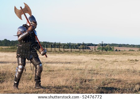 stock-photo-medieval-knight-in-the-field-with-an-axe-52476772.jpg